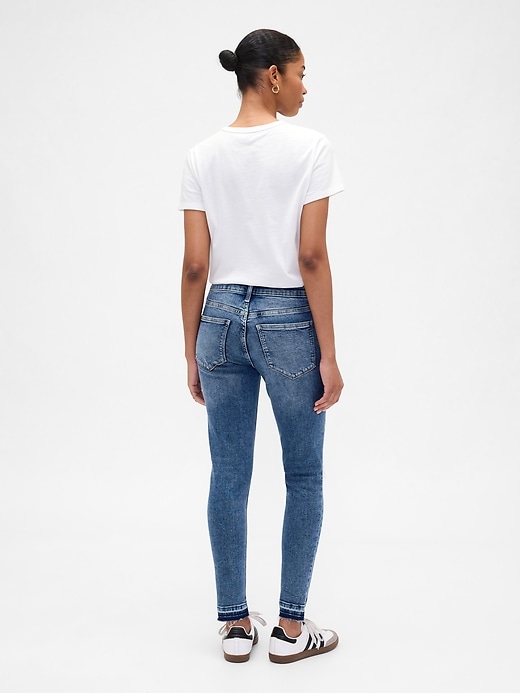 Image number 4 showing, Mid Rise Destructed Universal Skinny Jeans